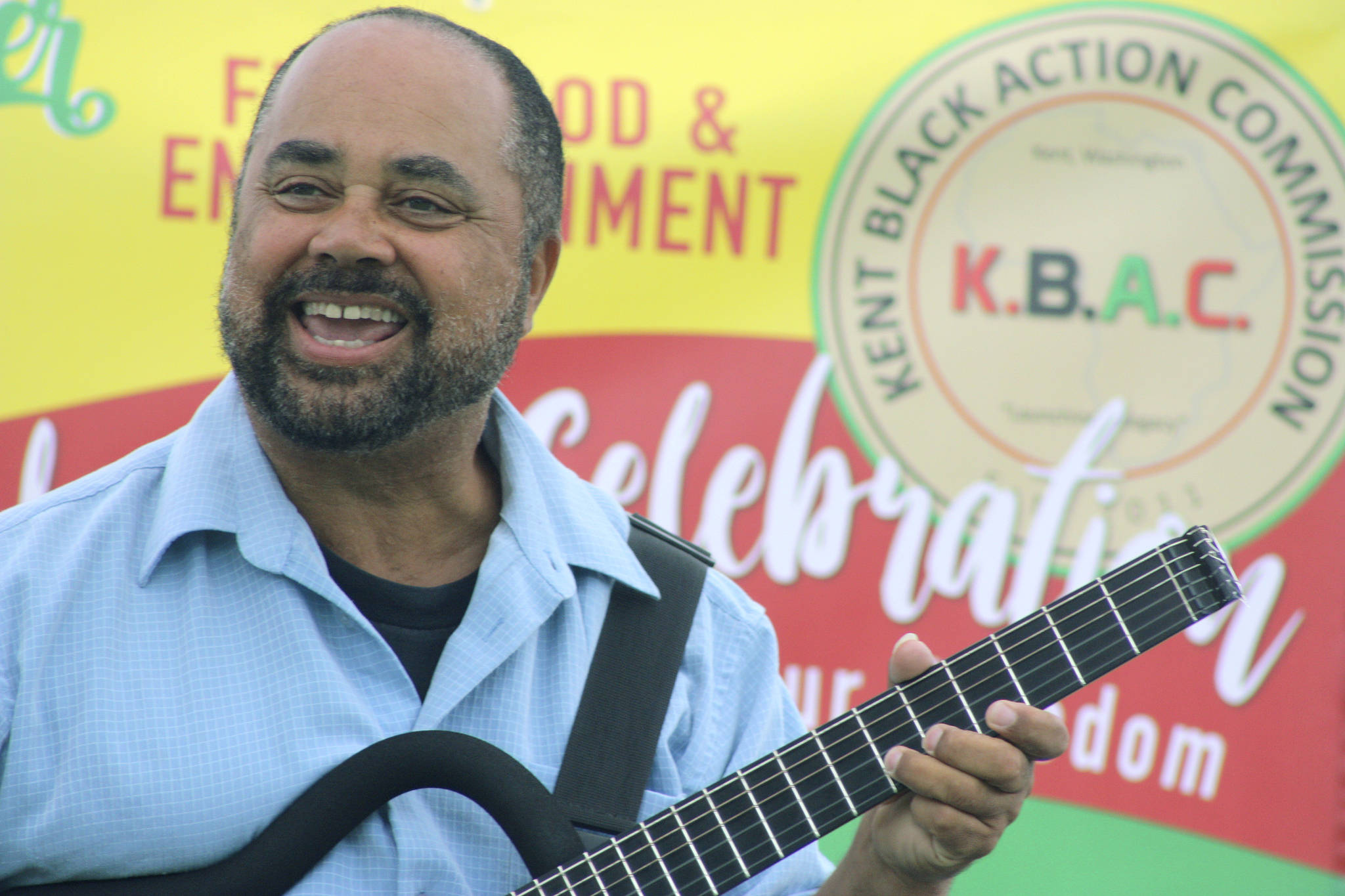 Jazz guitarist Michael Powers cranks up the music from center stage during the Juneteenth celebration at Morrill Meadows Park. MARK KLAAS, Kent Reporter