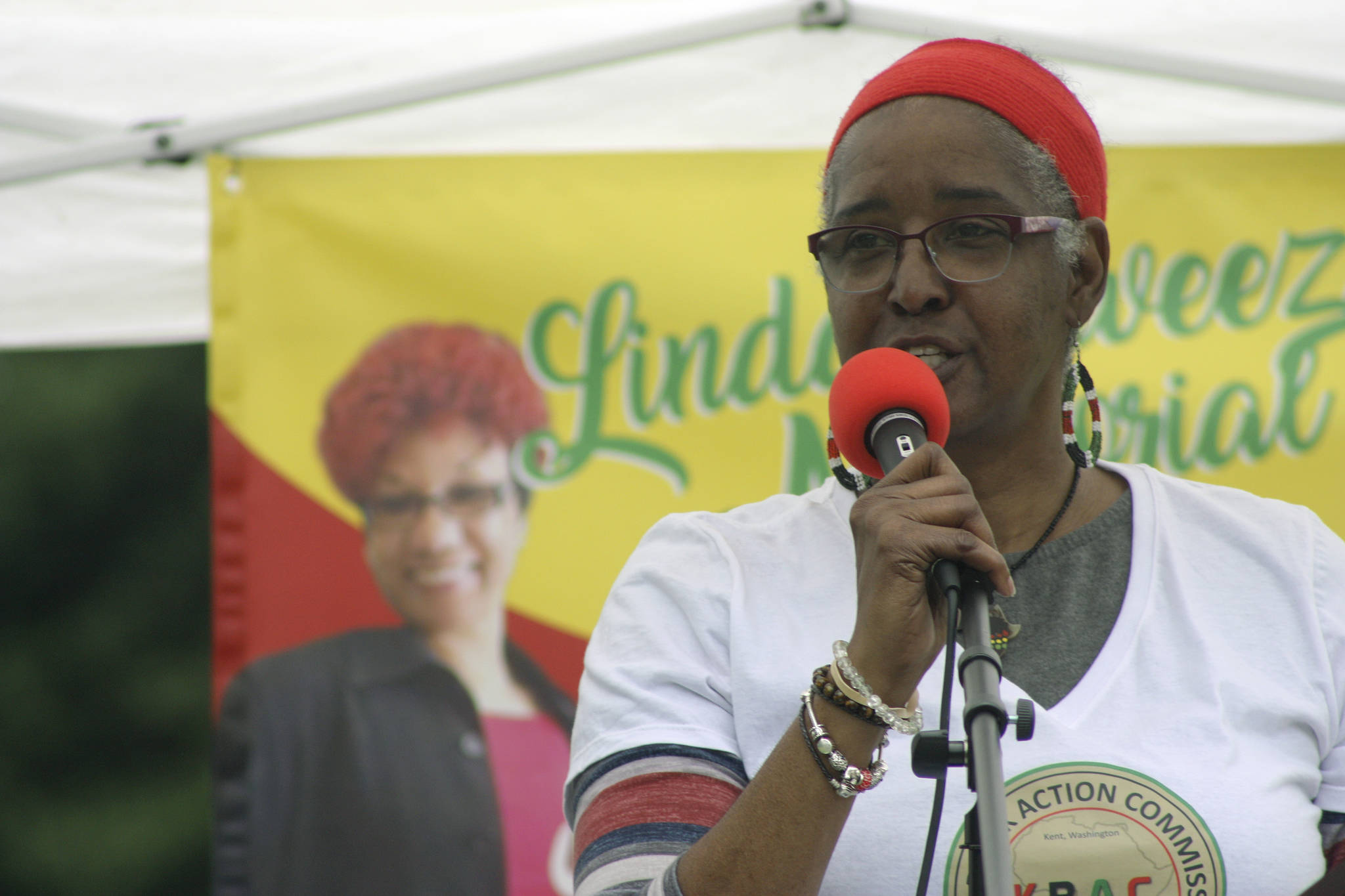 Gwen Allen-Carston, executive director of Kent Black Action Commission, welcomes the audience to the Juneteenth Festival and Celebration at Morrill Meadows Park last Saturday. The event was held in memory of the late Linda Sweezer, a KBAC member. MARK KLAAS, Kent Reporter
