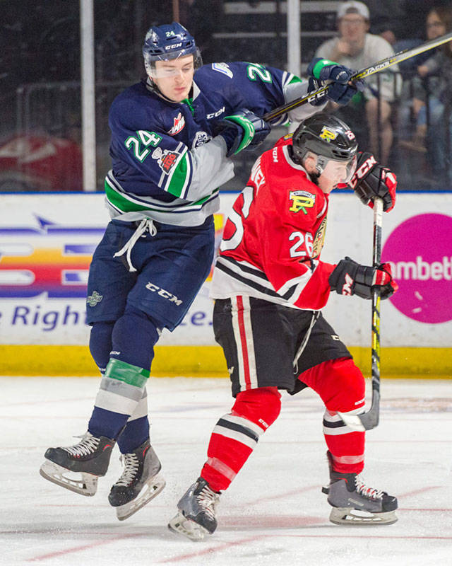 The Thunderbirds’ Donovan Neuls, left, collides with the Winterhawks’ Mason Mannek during WHL play last season. The I-5 rivals tangle again in Seattle’s home opener Sept. 22. COURTESY PHOTO, Brian Liesse, T-Birds