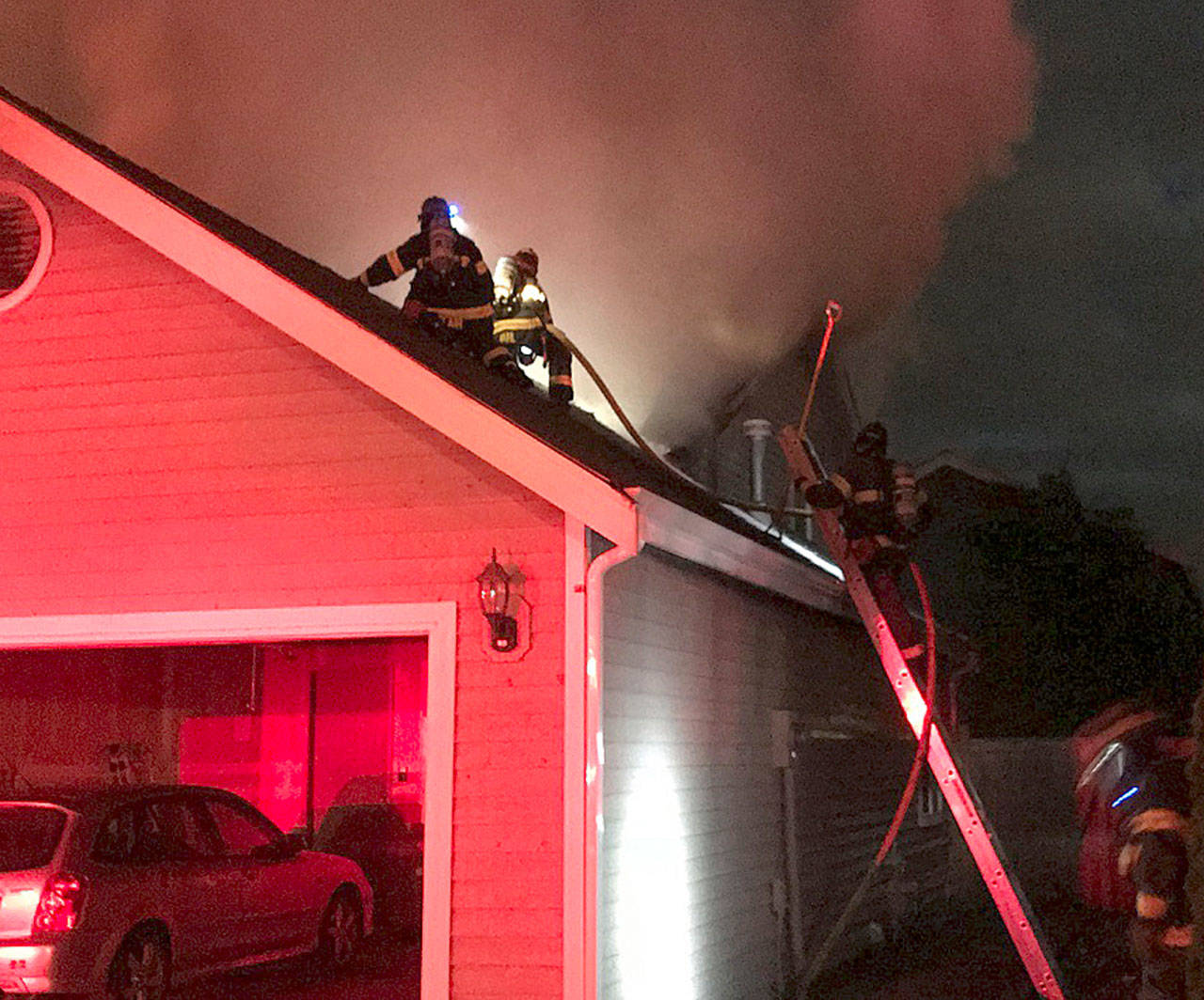 Firefighters tackle a house fire early Thursday morning in the 13300 block of Southeast 263rd Place. COURTESY PHOTO, Puget Sound Fire