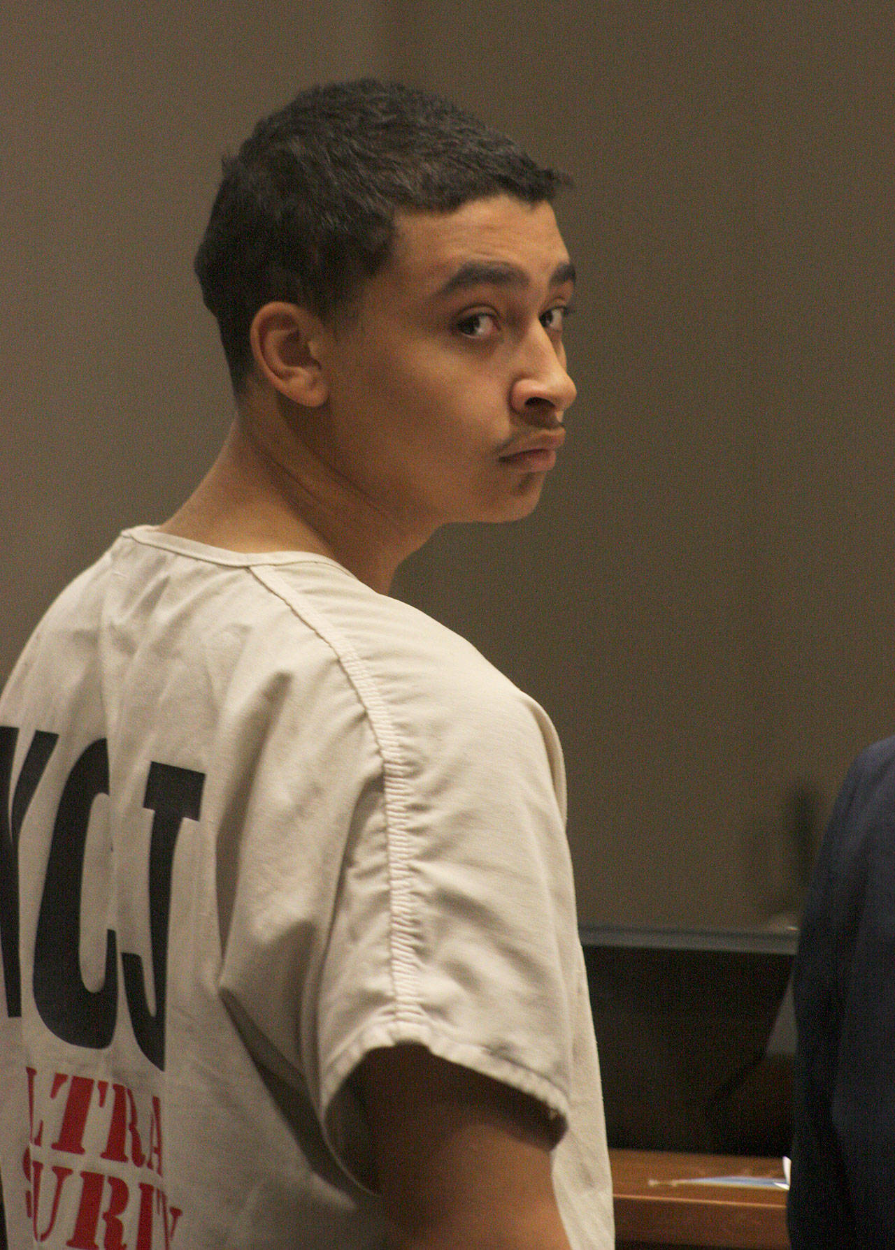 Giovanni D. Herrin glances back during his arraignment in King County Superior Court at the Maleng Regional Justice Center on Tuesday. Herrin pleaded not to a first-degree murder charge and to a second-degree escape charge. MARK KLAAS, Kent Reporter