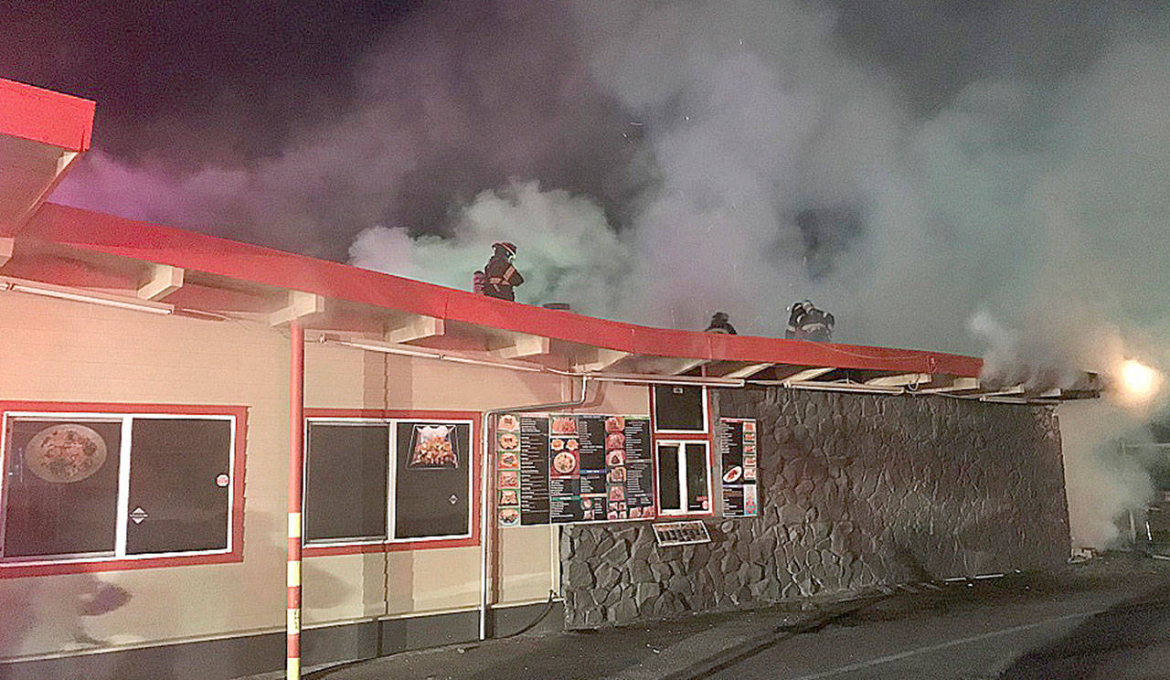 Firefighters attack a blaze early Thursday morning at Country Burger and Teriyaki, 1605 W. Meeker St. COURTESY PHOTO, Puget Sound RFA