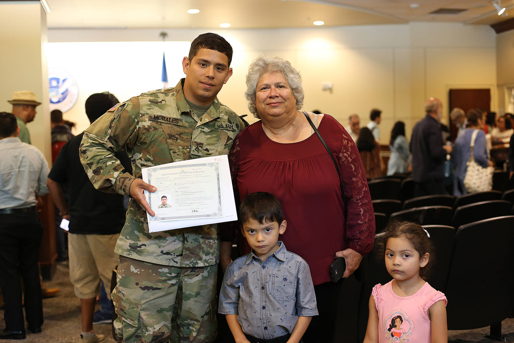 Pvt. 1st Class Aquiles R. Morales Centeno of Headquarters and Headquarters Company, 3rd Battalion, 161st Infantry Regiment, 81st Stryker Brigade Combat Team, poses for a photo with his mother, Elena, nephew, Joshua, and niece, Nicole after reciting the Naturalization Oath of Allegiance to the United States of America to become a naturalized citizen of the U.S. July 17, 2018 in Tukwila. Pfc. Morales is a native of Nicaragua but joined the Washington National Guard with the goal of earning his college degree. COURTESY PHOTO, U.S. Army National Guard, Sgt. 1st Class Jason Kriess.