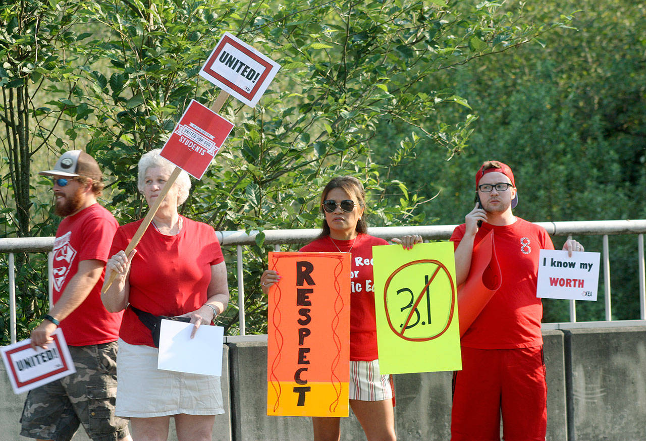 Kent teachers rally for better pay along Southeast 256th Street last Thursday, Aug. 9. The teachers union and the school district have yet to settle the dispute over salaries. MARK KLAAS, Kent Reporter