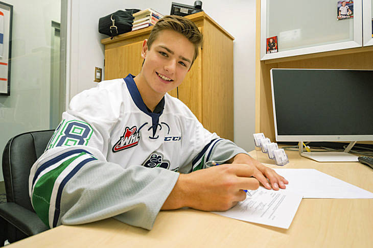 Kai Uchacz signs a WHL Standard Player Agreement with the Thunderbirds on Monday. COURTESY PHOTO, Brian Liesse, T-Birds