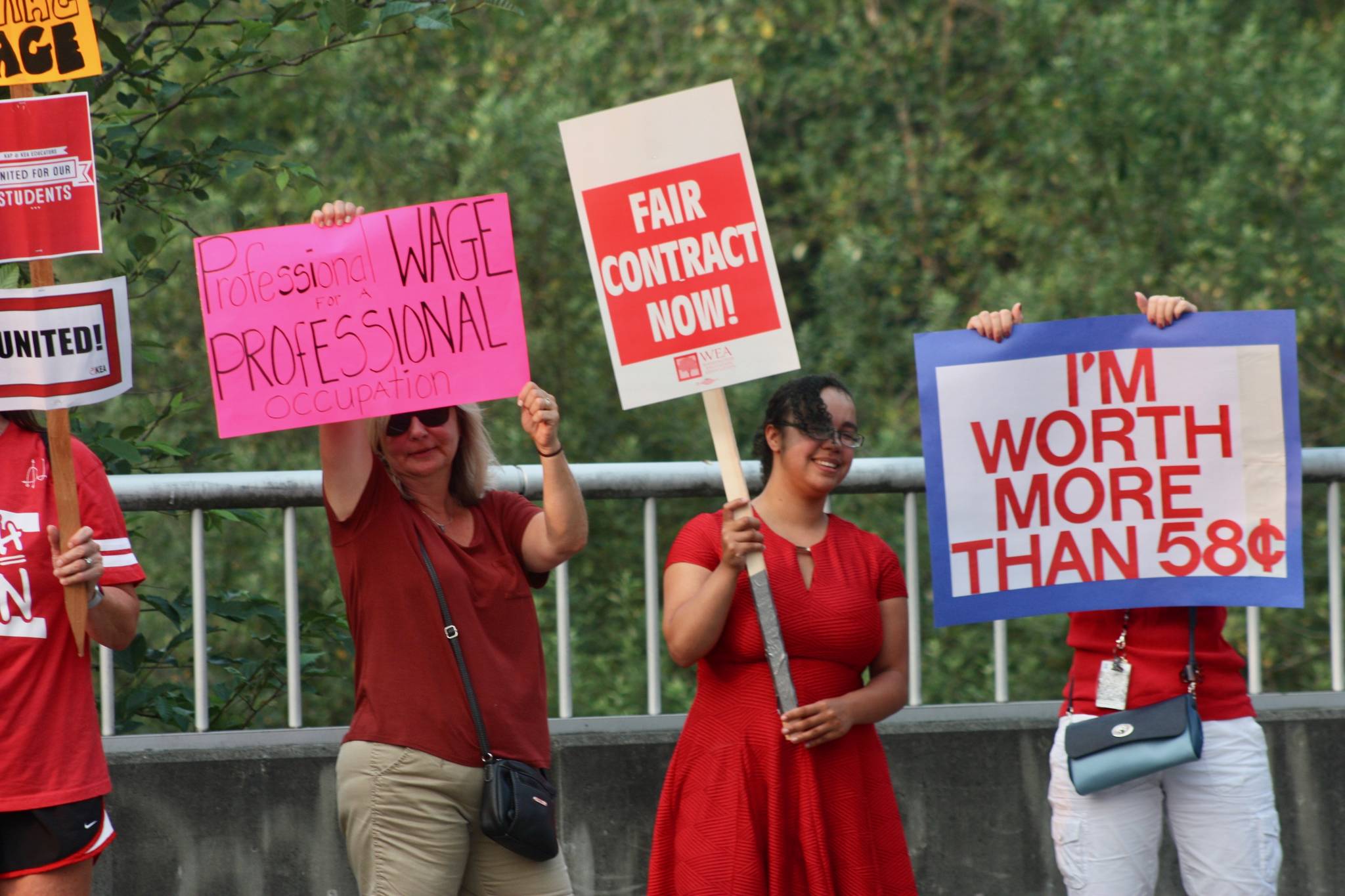 Teachers and paraeducators rally along Southeast 256th Street, outside the Kent School District Office, on Wednesday. Teachers and paraeducator unions and the school district have yet to settle the dispute over salaries. MARK KLAAS, Kent Reporter
