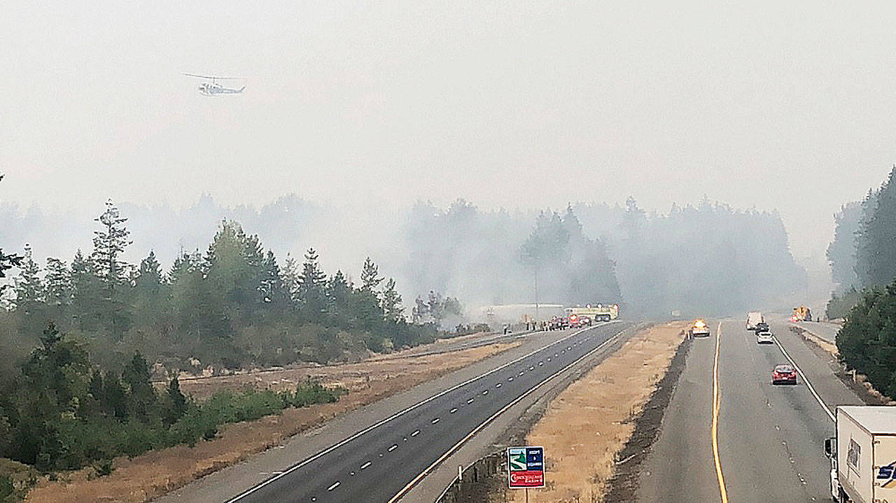 A helicopter approaches the scene of the brush fire Aug. 19 near Highway 18 in Covington. COURTESY PHOTO, Puget Sound Fire