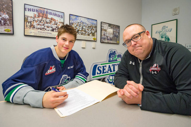 Jared Davidson signs a Standard WHL Player Agreement with the Thunderbirds on Thursday as general manager Bil La Forge looks on. COURTESY PHOTO, Brian Liesse, T-Birds