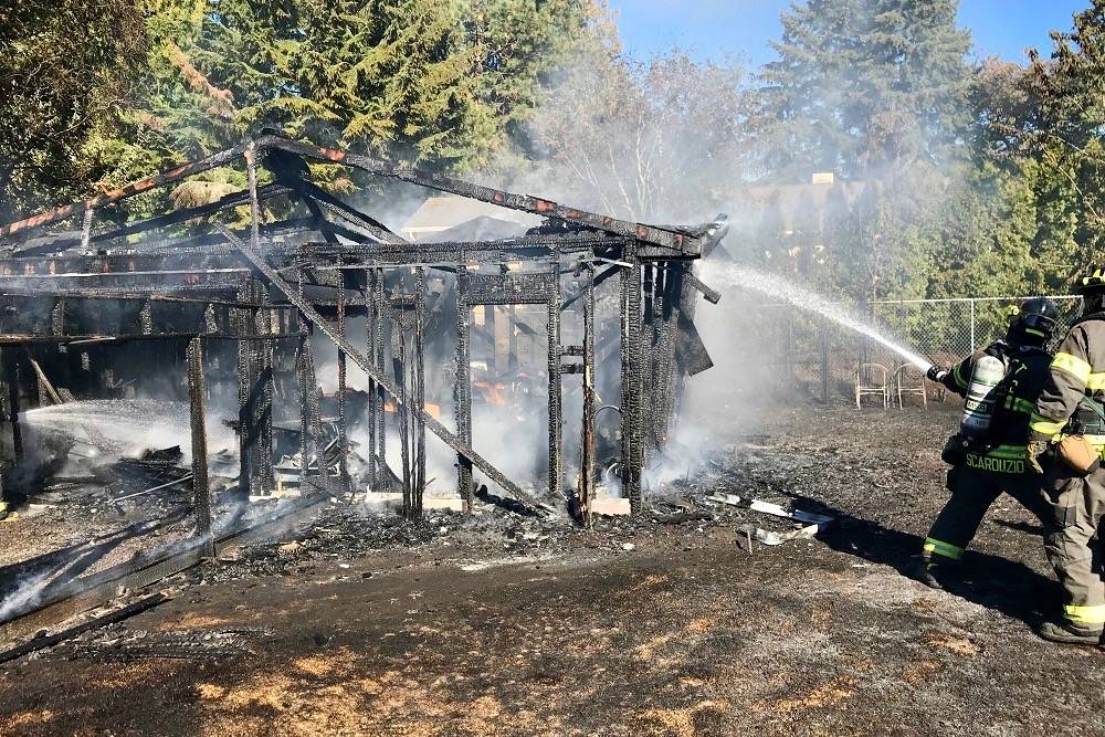 Detached garage fire damages two homes, scorches trees