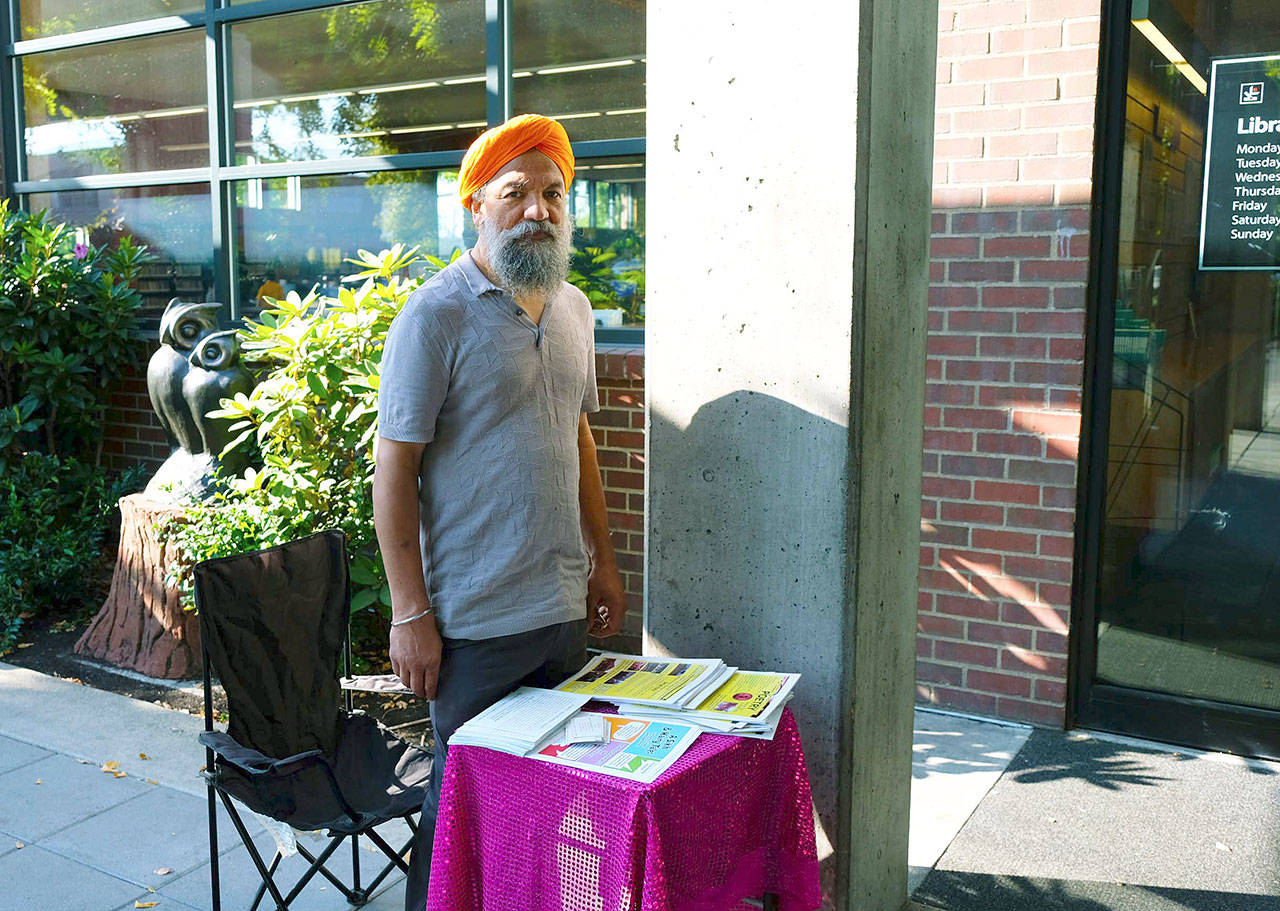 Sarab Singh, of the India-USA Magazine, occupies an information table outside the Kent Library. COURTESY PHOTO
