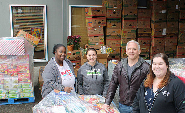 Camico Rivon, assistant director of Kent Food Bank, Jeniece Choate, executive director of Kent Food Bank, Torklift Central owner Jack Kay and Torklift Central employee Kerstin Stokes look on as goods are delivered in 2017 for Thanksgiving to the Kent Food Bank. COURTESY PHOTO, Torklift Central