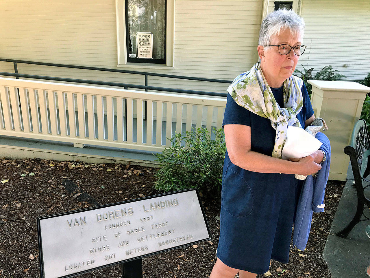 Nancy Simpson, city Landmarks Commissioner, stands by one of eight plaques that represent the historical Green River landings at a dedication ceremony for the new outdoor exhibit outside the Kent Historical Museum last week. MARK KLAAS, Kent Reporter