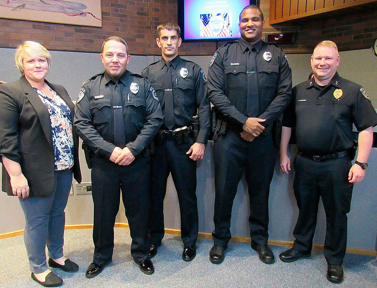 Kent Mayor Dana Ralph, far left, and Assistant Chief Derek Kammerzell, far right, pose with new Kent Police Officers Justin Campbell, second from left, Brandon Hamilton and Kelly Robinson after their swearing in ceremony Sept. 18 at City Hall. COURTESY PHOTO, City of Kent
