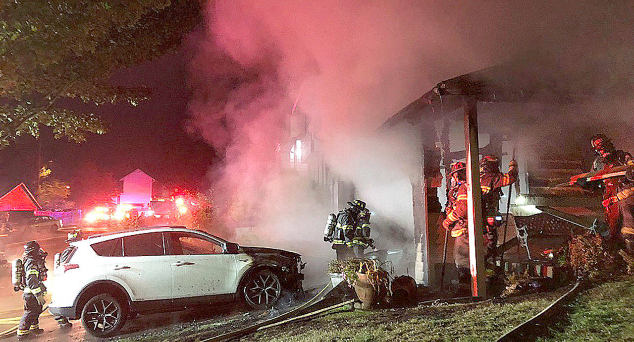 Firefighters battle a blaze early Thursday morning at a Kent home in the 26500 block of 115th Place Southeast. COURTESY PHOTO, Puget Sound Fire