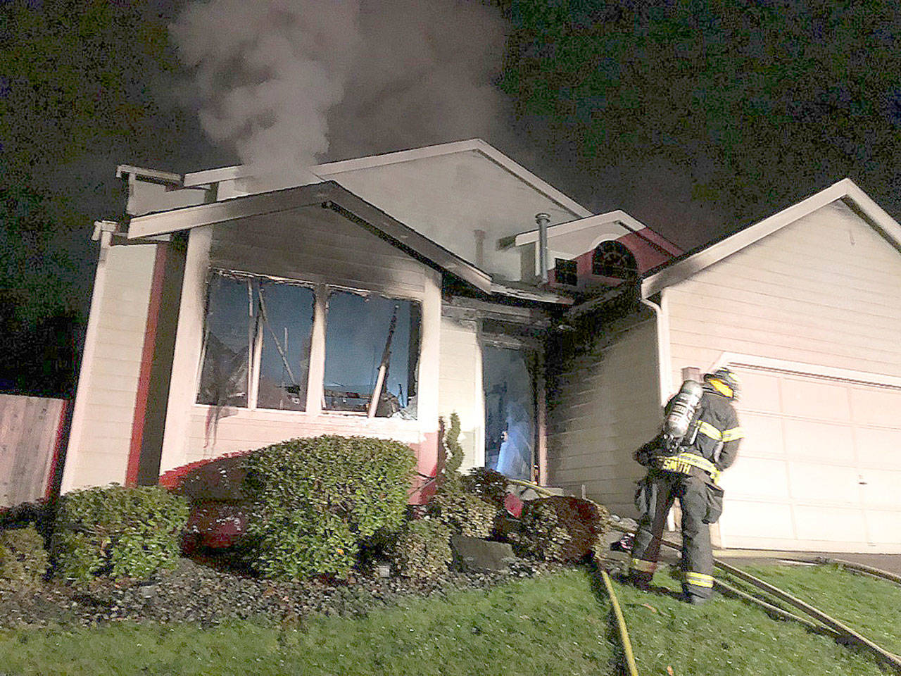 Kent firefighters battle a blaze Sunday night at a house in the 12400 block of Southeast 238th Place. COURTESY PHOTO, Puget Sound RFA