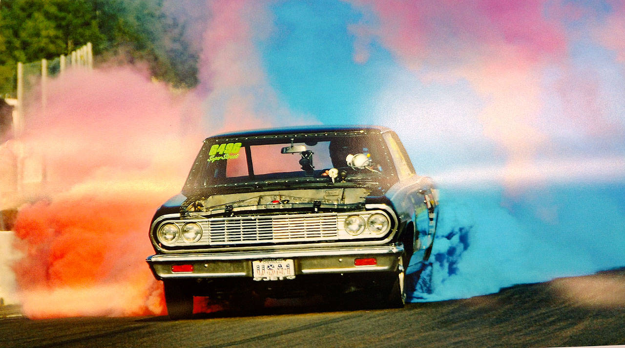 Ron Buckholz burns rubber as he steers down the drag strip at Pacific Raceways during his attempt at setting the world record for longest distance of a car burnout. COURTESY PHOTO