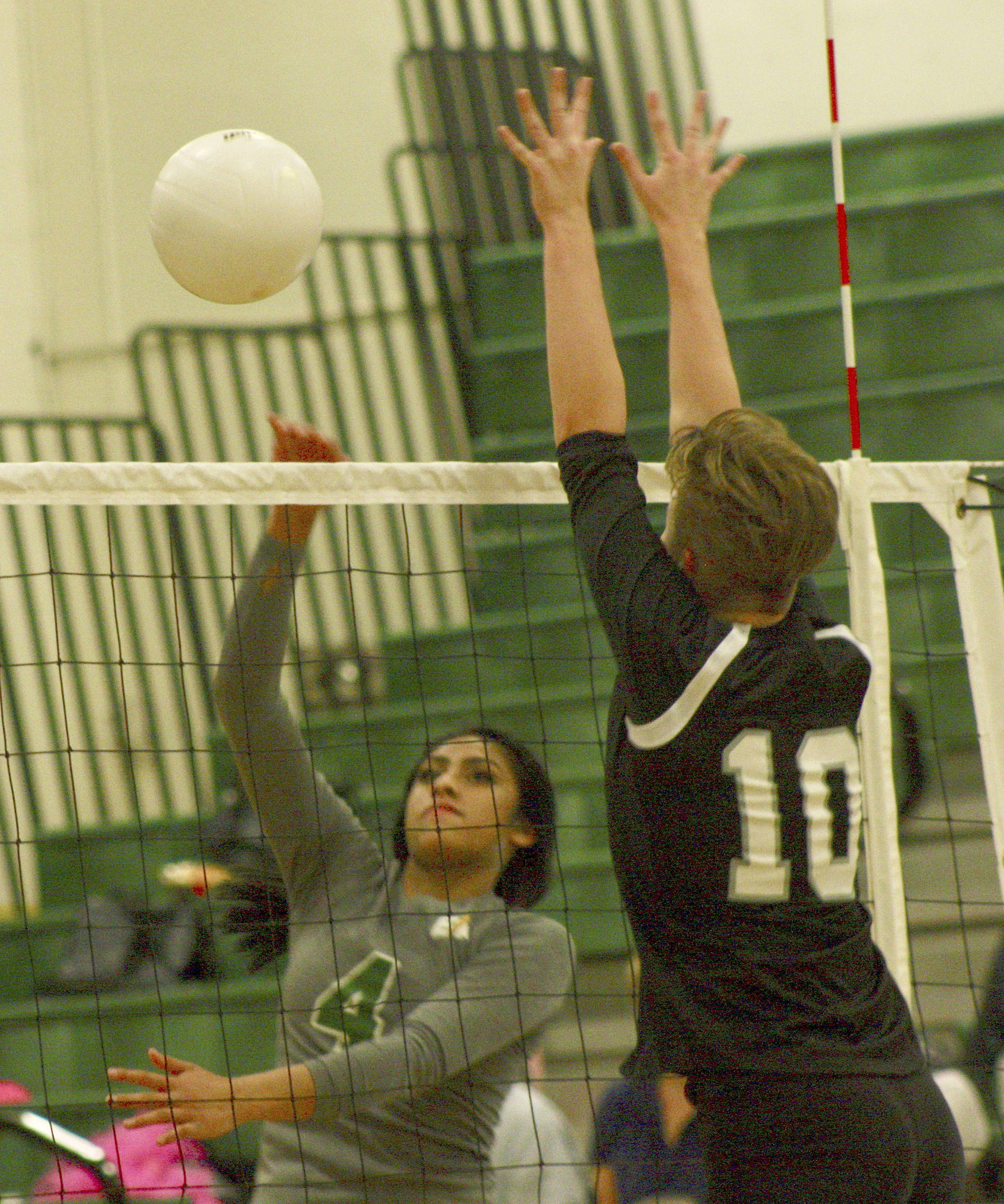 Kentridge’s Zaiah Calvin fires a shot past Kentlake’s Chloe Hawker during Thursday’s match. She had 12 kills and four digs in the three-game victory. MARK KLAAS, Kent Reporter