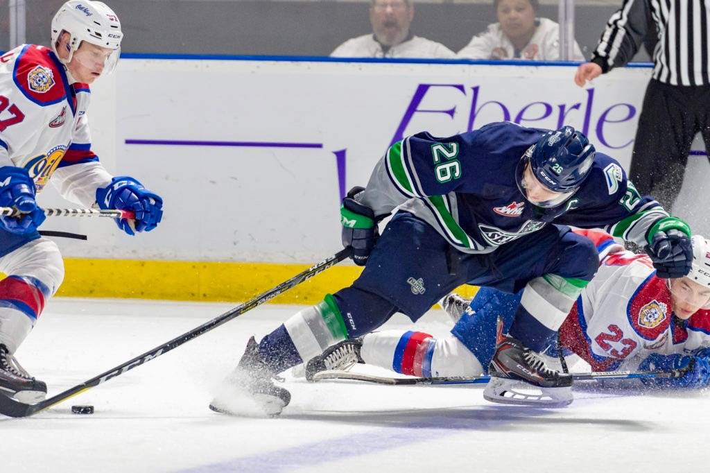 Thunderbirds captain Nolan Volcan tries to gain control of the puck between Oil King defenders during WHL play Saturday night. COURTESY PHOTO, Brian Liesse, T-Birds
