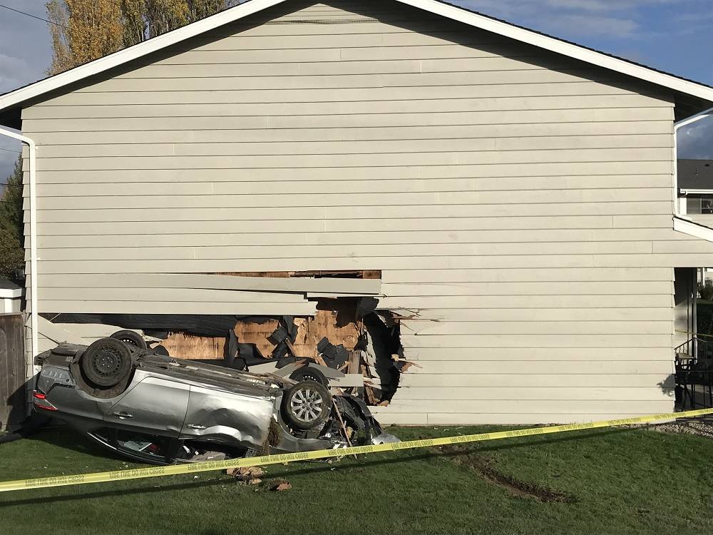 The driver of the sedan and two people in the townhouse were not hurt in the crash Sunday. COURTESY PHOTO, Puget Sound RFA