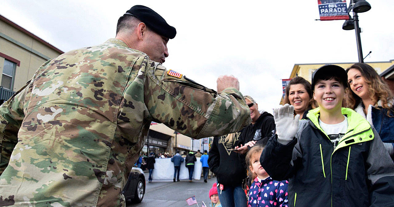 A veteran greets Keenan Stone along Main Street during last year’s Auburn Veterans Parade. RACHEL CIAMPI, Auburn Reporter