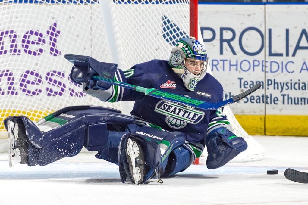 Thunderbirds goalie Liam Hughes falls to the ice in pursuit of the puck during WHL play Friday night. COURTESY PHOTO, Brian Liesse/T-Birds