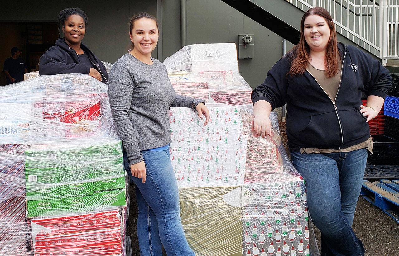 Camico Rivon, Kent Food Bank assistant director, far left, Jeniece Choate, Kent Food Bank executive director and Torklift Central employee Kerstin Stokes prepare to sort through donations collected during the Kent Turkey Challenge at the Kent Food Bank. COURTESY PHOTO, Torklift Central