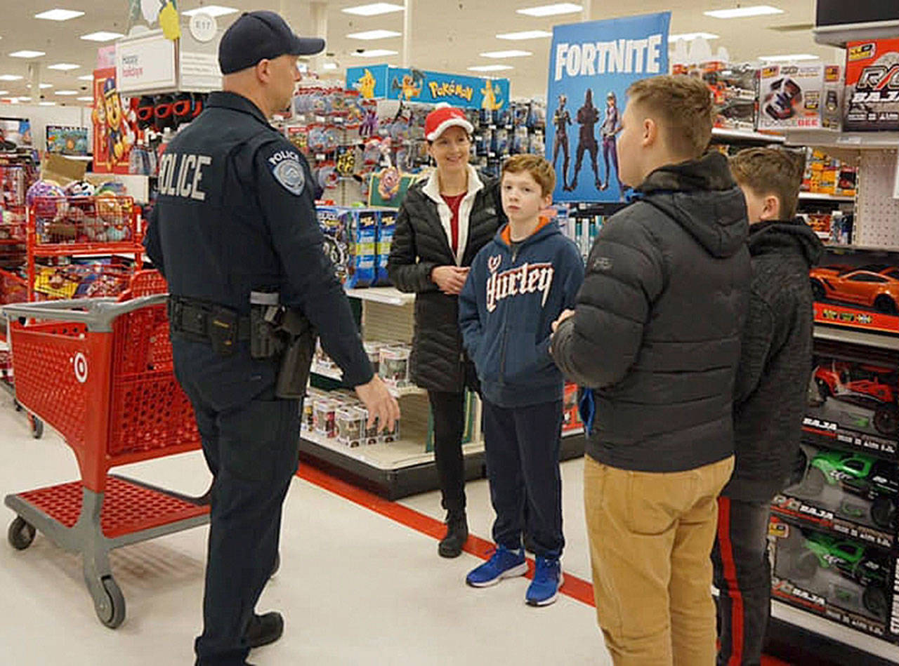 Kent Police help children shop for holiday gifts on Saturday, Dec. 8, at the Kent Target store. COURTESY PHOTO, Kent Police