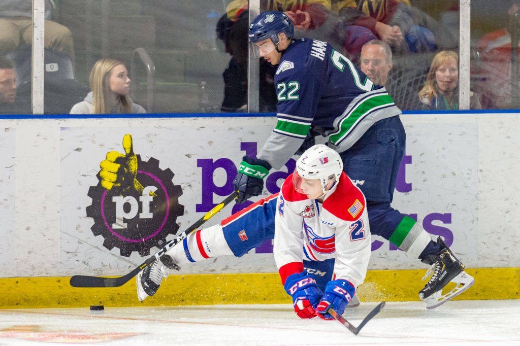 Thunderbirds winger Dillon Hamaliuk tries to drive the puck up the ice as Chiefs defenseman Luke Gallagher provides resistance during WHL play Friday night. COURTESY PHOTO, Brian Liesse, T-Birds