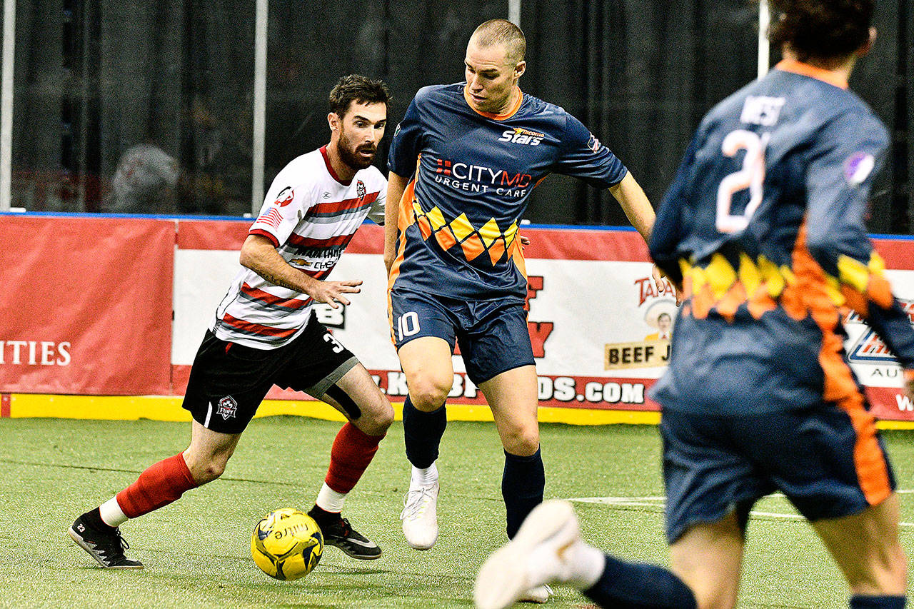 The Stars’ Nick Perera dribbles the ball through the Fury defense during MASL action Sunday. Perera won his first two games as player-coach. COURTESY PHOTO, Stars