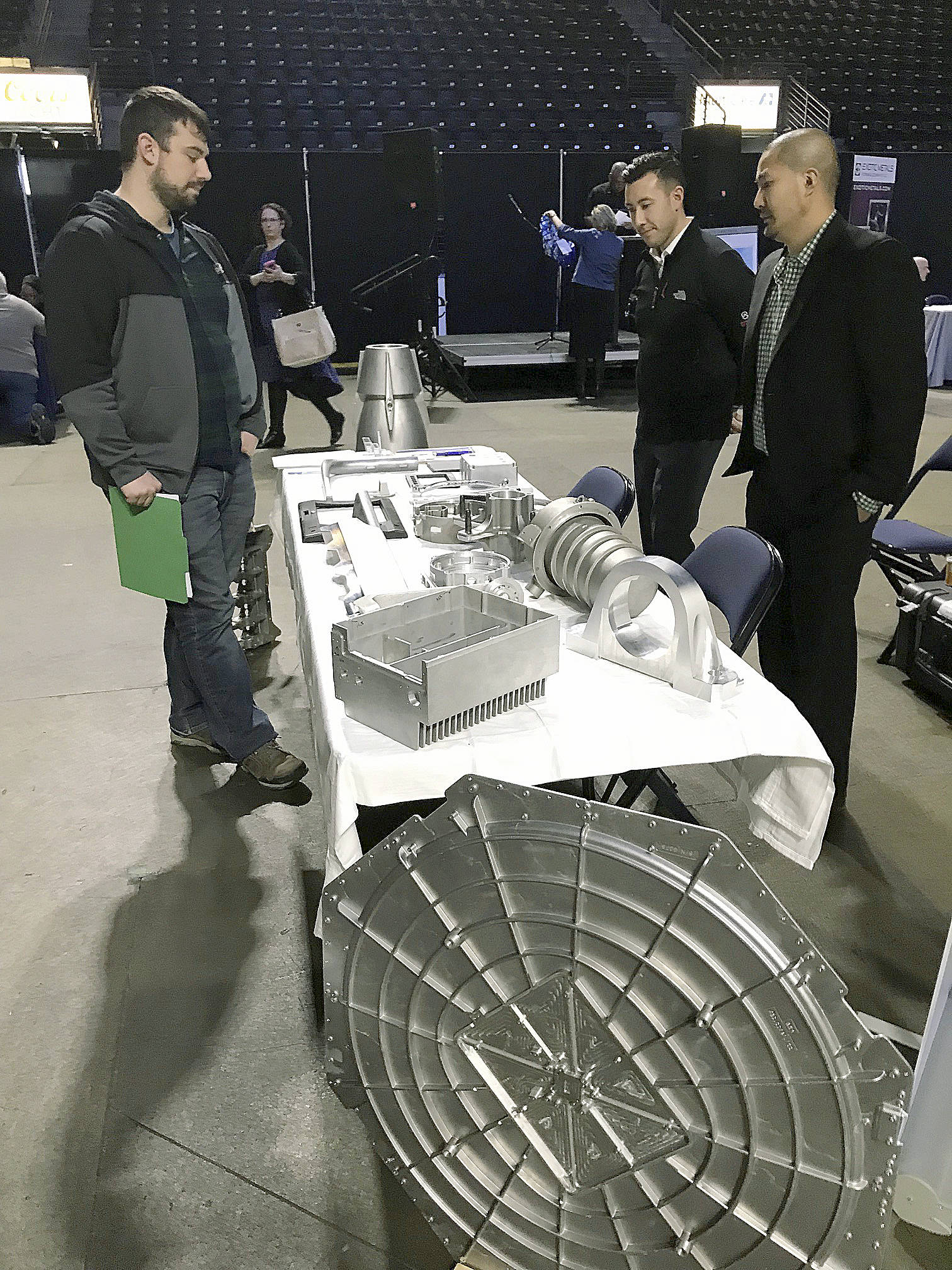 Representatives from Duvall-based Pentz Cast Solutions – a precision aluminum casting foundry – talks to a interested job seeker during the fair. MARK KLAAS, Auburn Reporter