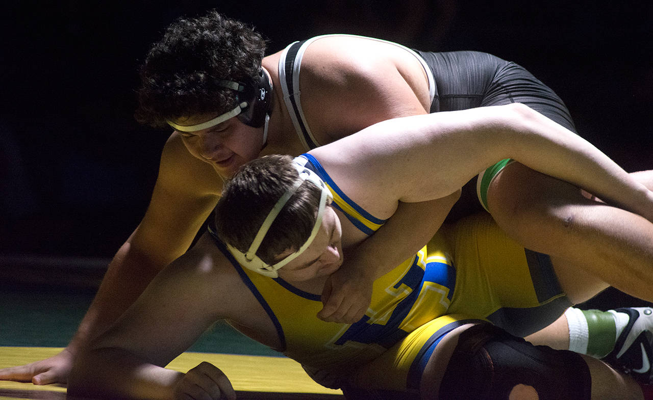 Kentwood’s Victor Juarez delivers a win by fall at 285 pounds. Kayse Angel, Covington Reporter