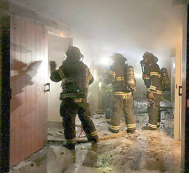 Puget Sound Fire firefighters fight a blaze last June at the Lake Meridian Park bathhouse. COURTESY PHOTO, Puget Sound Fire