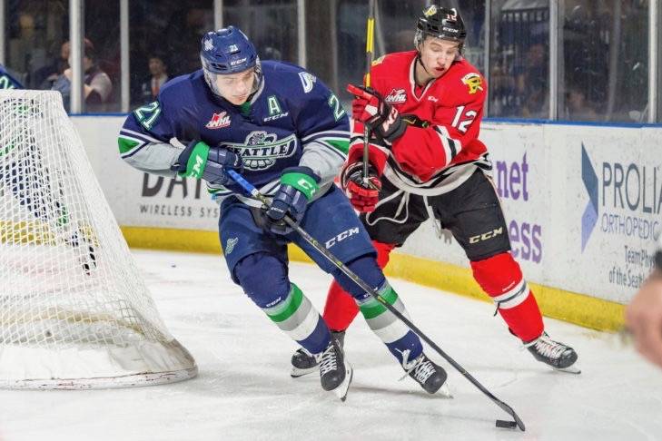 The Thunderbirds’ Matthew Wedman controls the puck in front of the Winterhawks’ Reece Newkirk during WHL play. COURTESY PHOTO, Brian Liesse, T-Birds