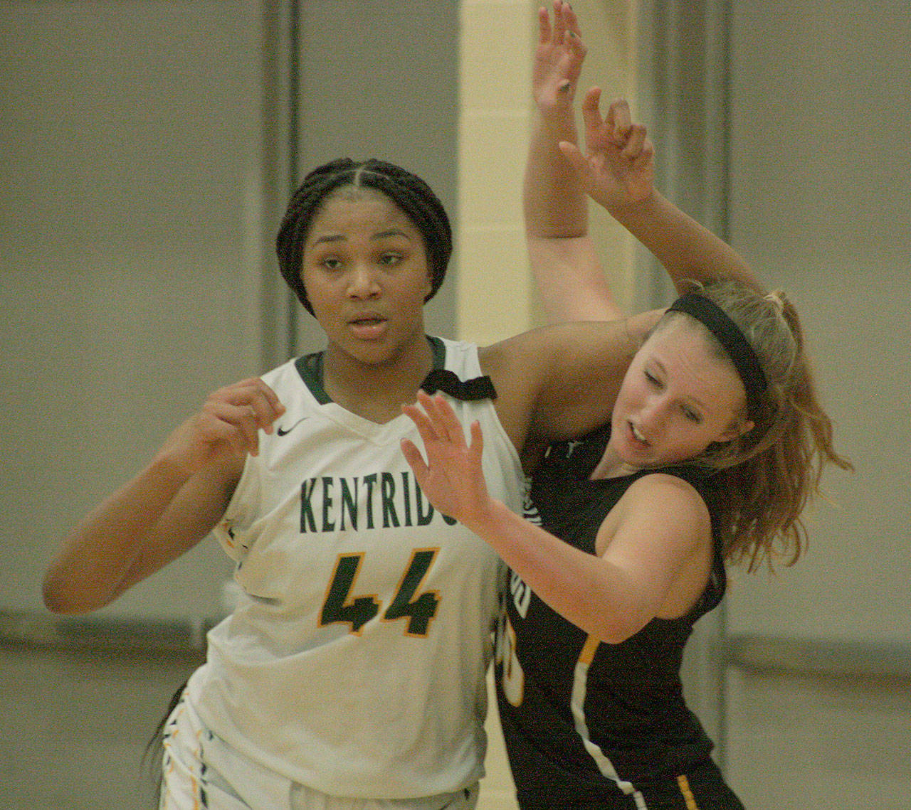 Kentridge’s JaQuaya Miller tangles with Inglemoor’s Abby Haller for position during 4A regional play at Auburn Mountainview High School on Saturday. Miller had 24 points and 20 rebounds in the Chargers win. MARK KLAAS, Kent Reporter