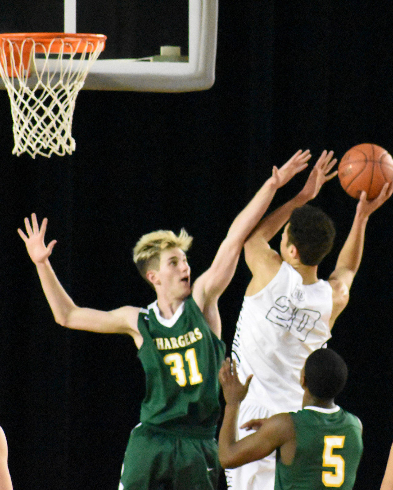 Kentridges Owen Paznokas looks to deny a shot by Battle Grounds Kaden Perry during the Chargers 66-54 opening-round win at the 4A Hardwood Classic on Wednesday. COURTESY PHOTO, Kevin Hanson, Enumclaw Courier-Herald