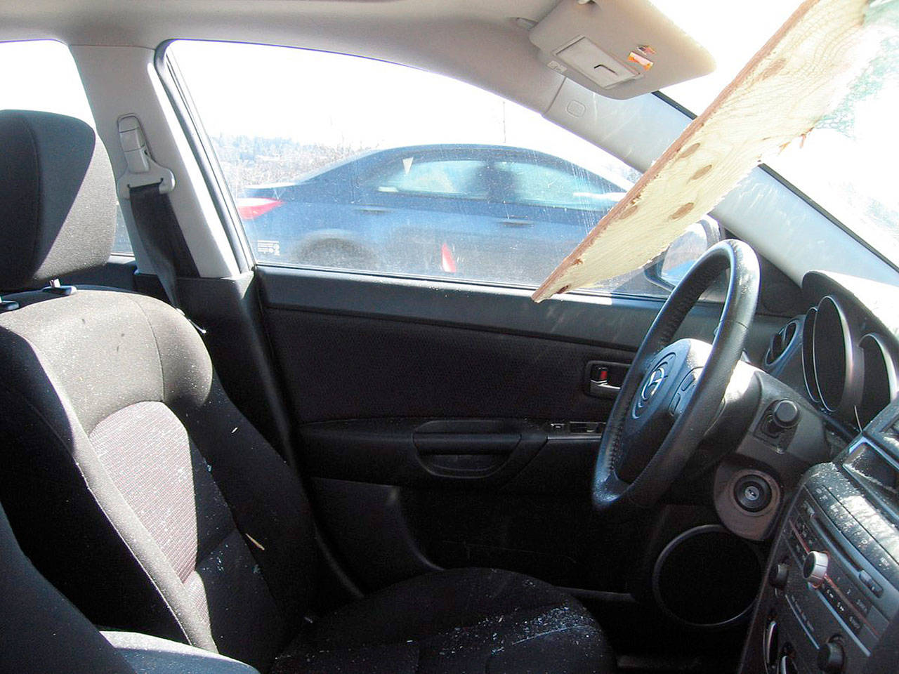 A driver suffered only minor scratches from glass splinters after a piece of lumber from an unsecured load went through the vehicle’s windshield around noon Tuesday along Highway 167 southbound in Kent near the 84th Avenue South exit. The driver of the vehicle that lost the lumber did not stop. COURTESY PHOTO, State Patrol
