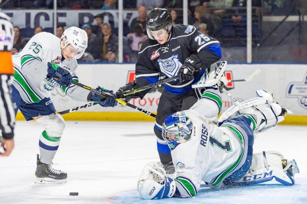 Thunderbirds goalie Roddy Ross reaches to stop the puck as defenseman Owen Williams and the Royals right winger Dino Kambeitz occupy the front porch during WHL play Friday night. COURTESY PHOTO, Brian Liesse, T-Birds