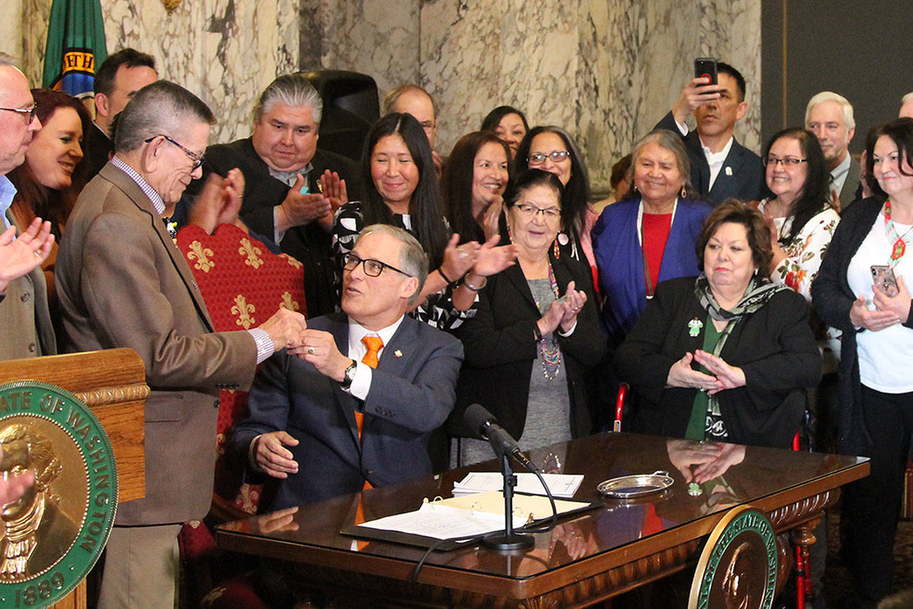 Gov. Jay Inlsee signs into law the Native American Voting Rights Act, which allows a non-traditional address to be used for voter registration for residents who live on reservations. Photo by Emma Epperly/WNPA Olympia News Bureau