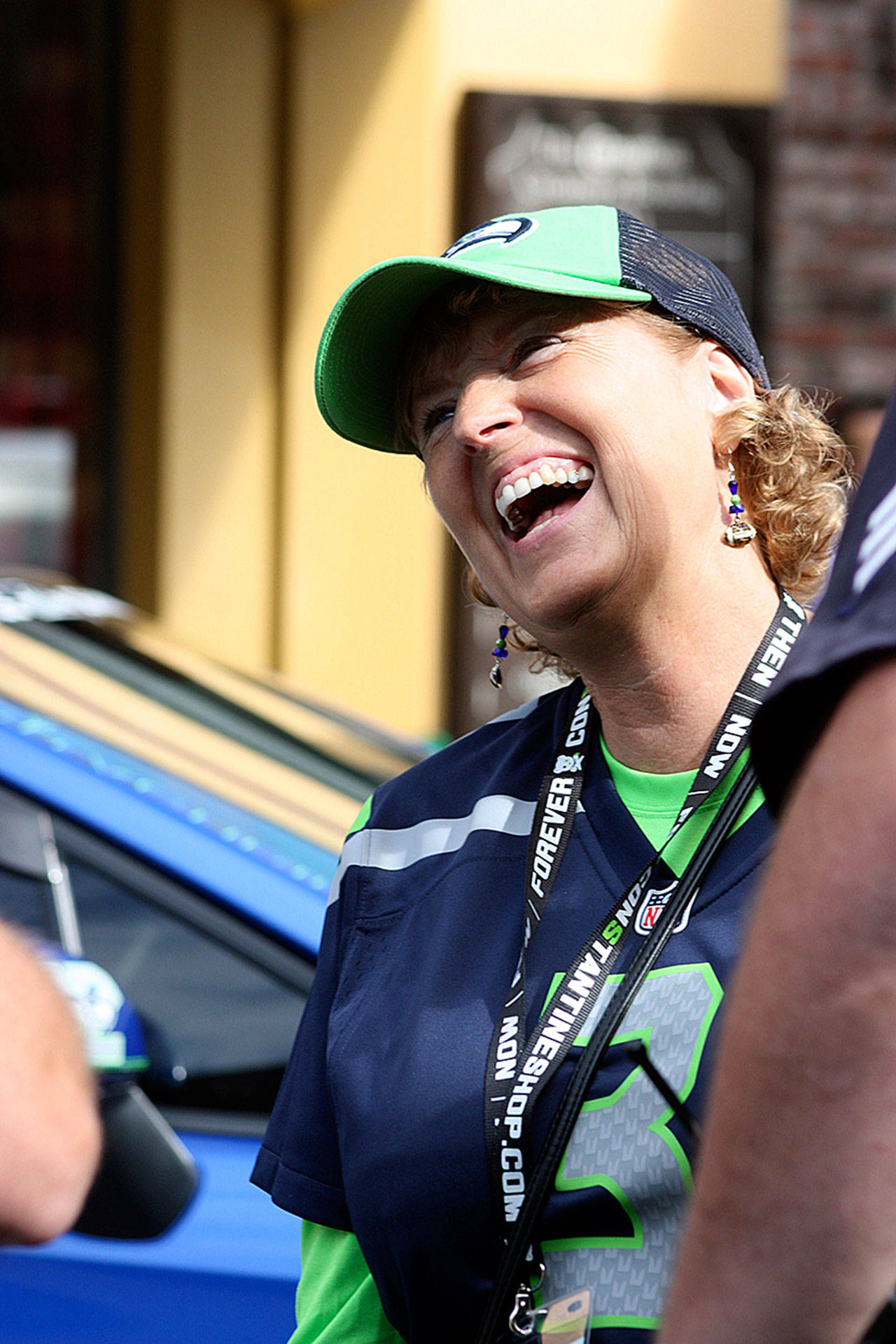 Barb Smith, executive director of the Kent Downtown Partnership, shares a laugh with visitors at the KDP’s 2016 Hawktoberfest Car Show in downtown Kent. Smith received the Leadership on Main Award for her work in Kent. MARK KLAAS, Kent Reporter