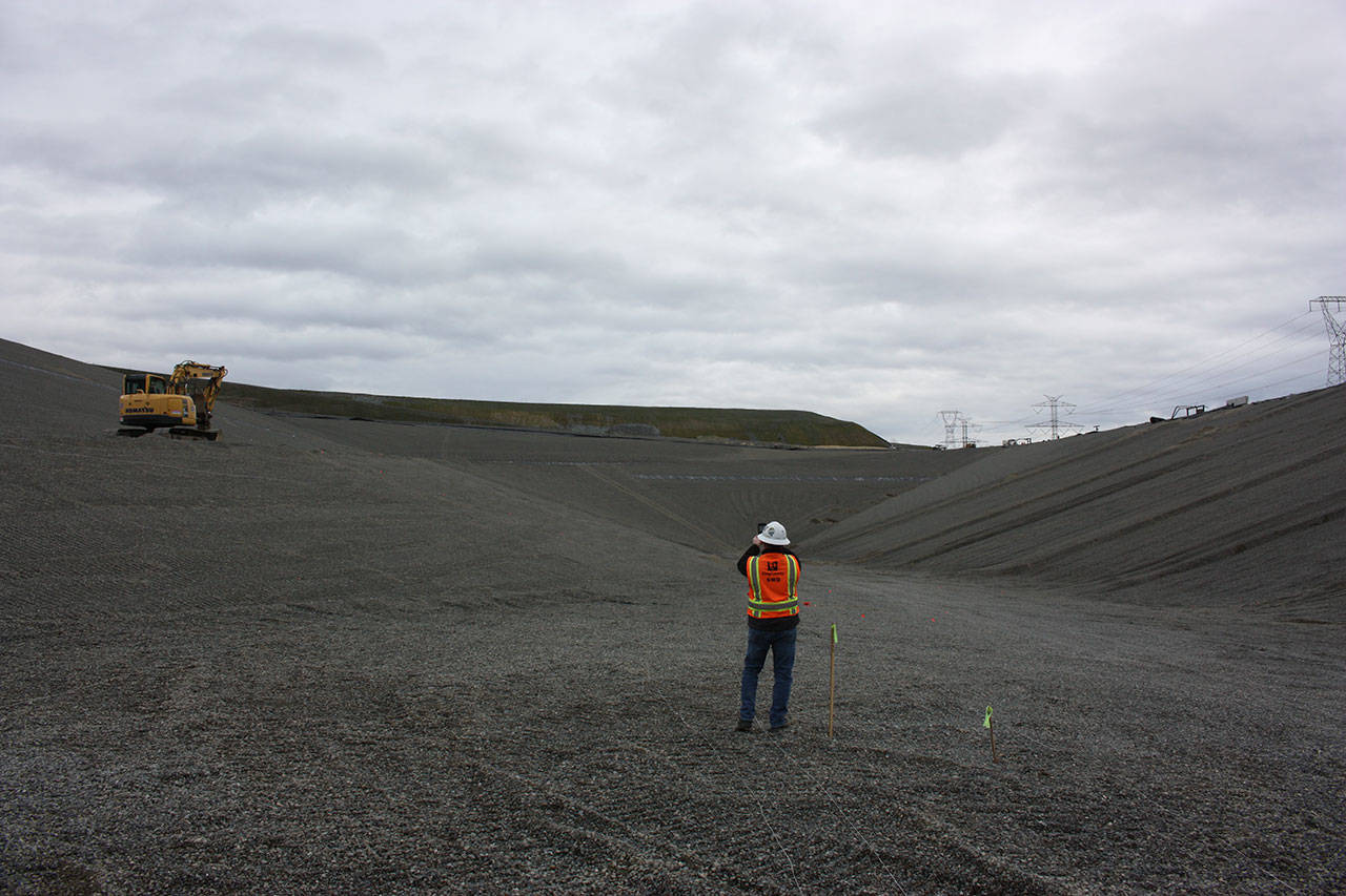 Scott Barden stands at the bottom of the massive pit of the landfill’s newly-built eighth section. Work on the new section has been underway for around two years. Aaron Kunkler/staff photo