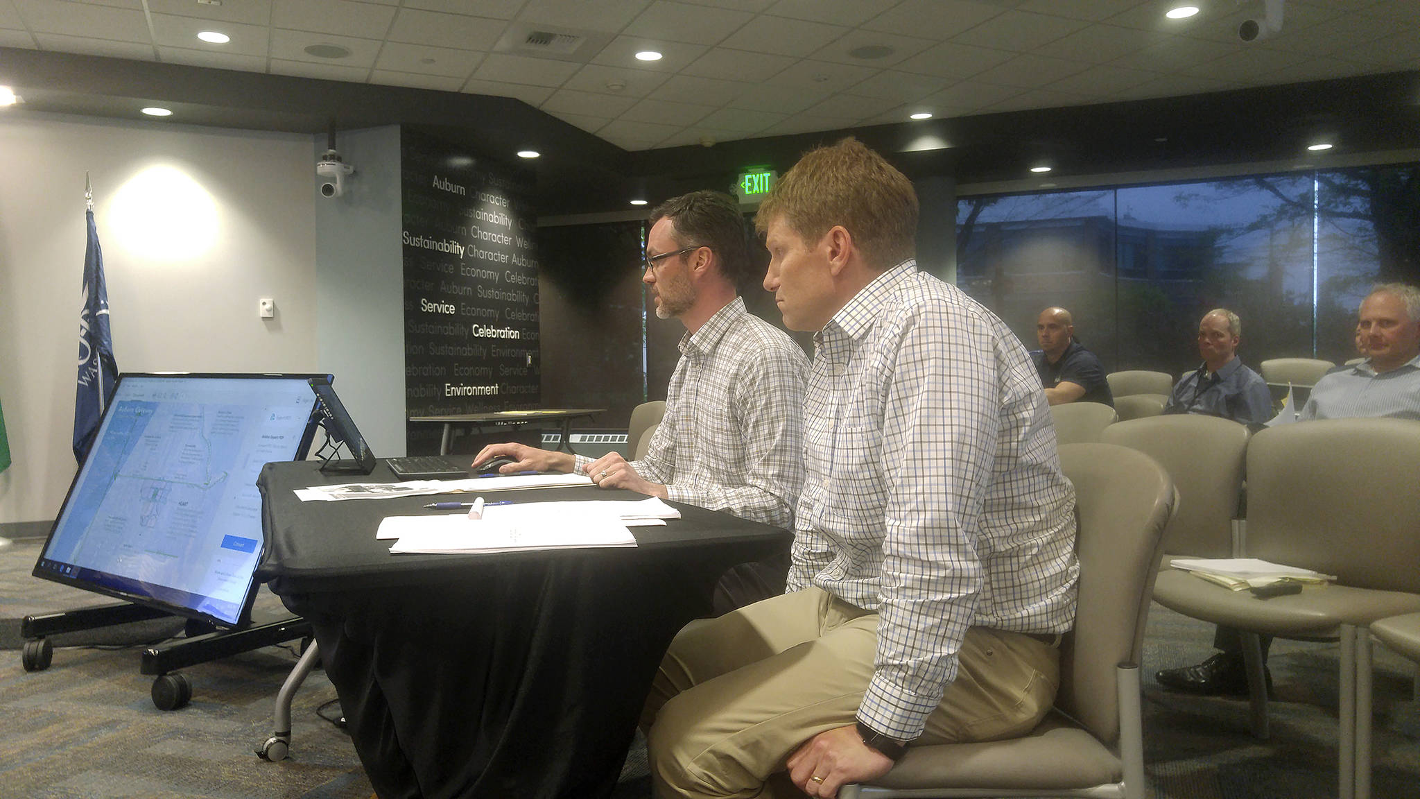 Scott Morris, foreground, and John Fisher of Inland Construction explain to the Auburn City Council their proposal for developing the long-dormant, former Valley 6 Drive-In Theaters property. ROBERT WHALE, Auburn Reporter
