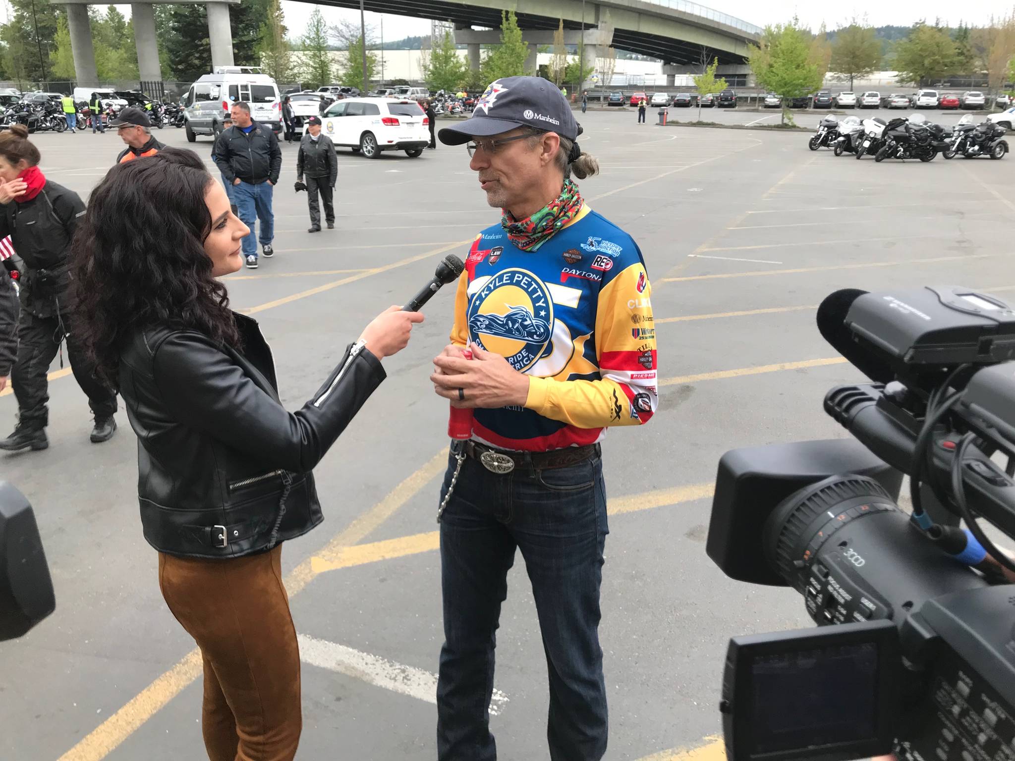 Kyle Petty conducts an interview with a TV reporter before beginning his annual Charity Ride Across America. Petty was gracious with his time with media, fans and sponsors. MARK KLAAS, Kent Reporter