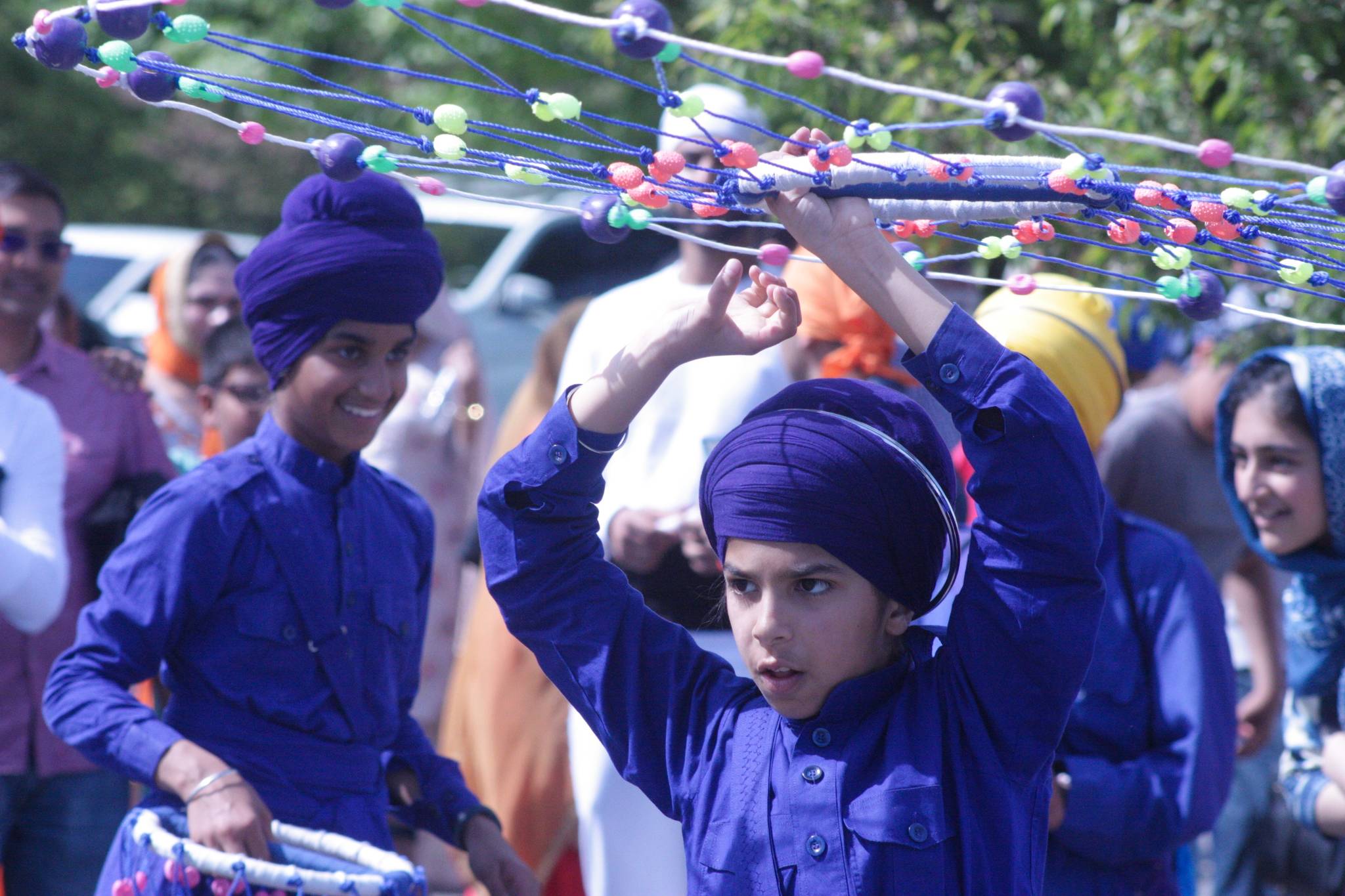 A young Sikh boy twirls a Chakkar, a ceremonial ring, during the Khalsa Day Parade in Kent on Saturday. The Chakkar was an ancient Indian weapon adopted by Sikhs as part of their standard battle gear centuries ago. MARK KLAAS, Kent Reporter