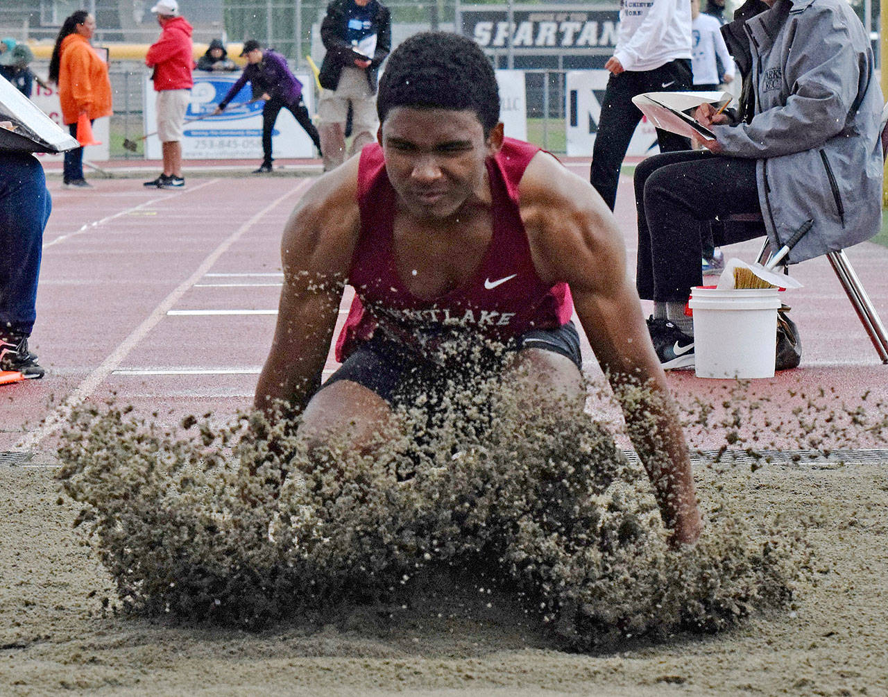 Kentlake’s Justice Etafo scatters the sand after his attempt in the long jump at the bi-district meet. Etafo finished second with a leap of 22 feet, ½ inch. RACHEL CIAMPI, Kent Reporter