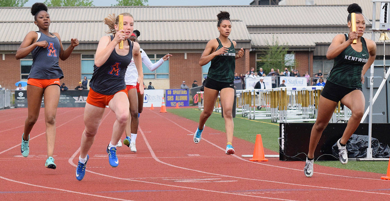Kentwood’s 800-meter relay captured the bi-district title in 1:41.50. Here, Faith Marshall passes the baton to MaKayla Williams, far right. RACHEL CIAMPI, Kent Reporter