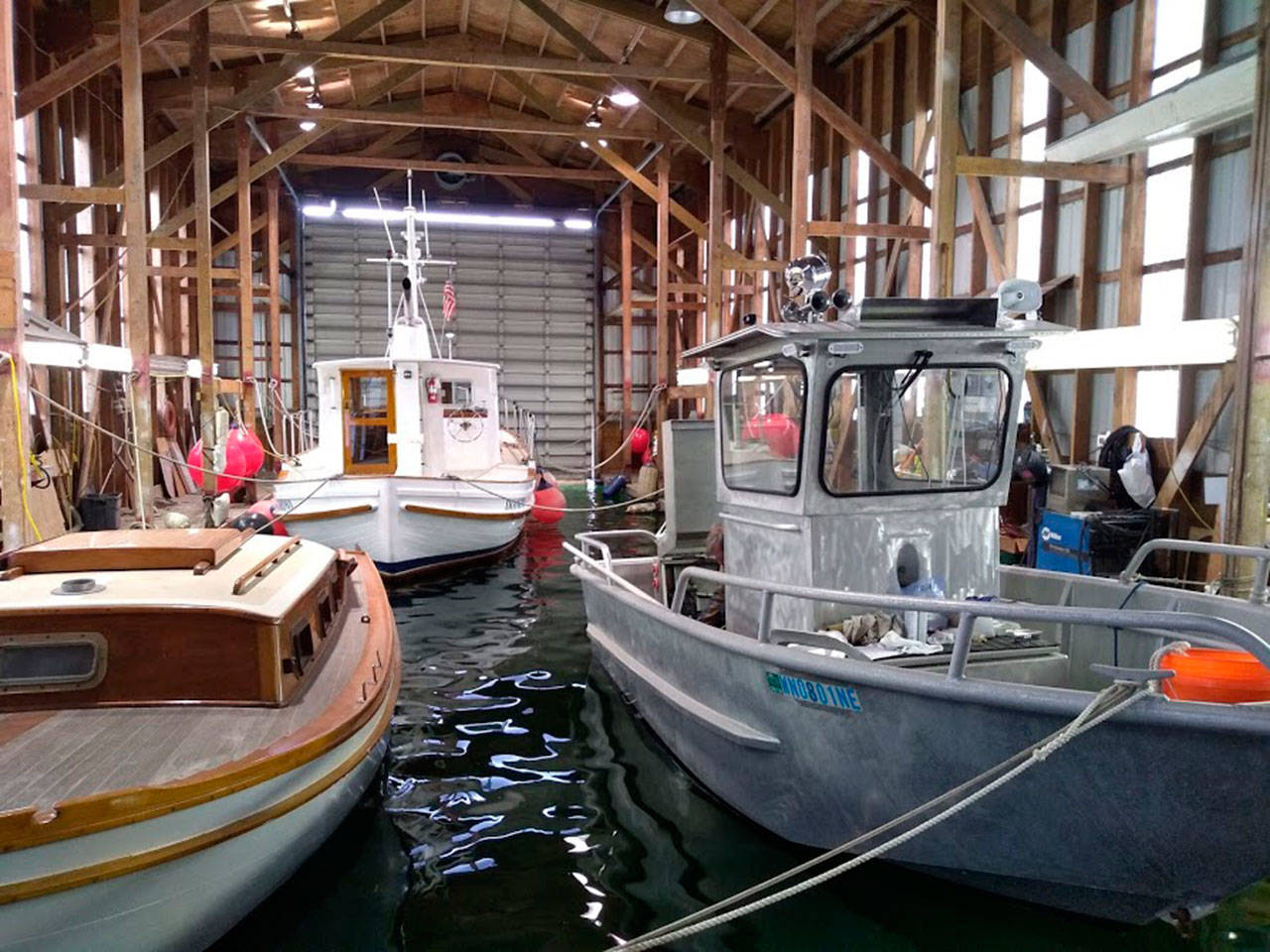 Dunato’s Boat Yard is building a smaller vessel, seen on the right, which will be used for reclamation efforts on Lake Sammamish and smaller waterways in the area. Aaron Kunkler/staff photo