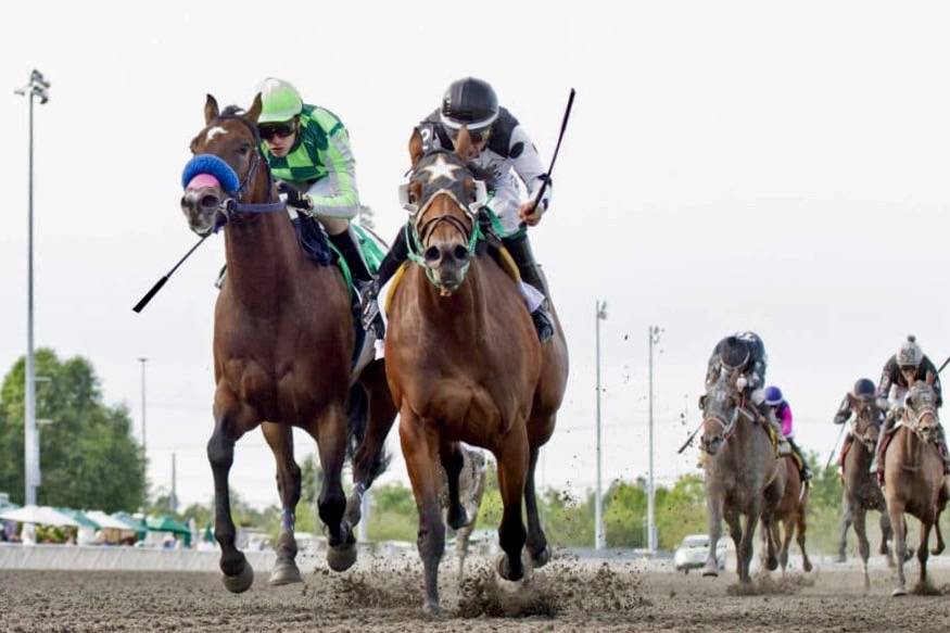 Alittlelesstalk, right, holds off Mucho Amor in the Kent Stakes at Emerald Downs on Sunday. COURTESY TRACK PHOTO