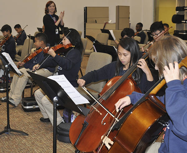 Monica Camp directs the orchestra at Excel Public Charter School. 2015 FILE PHOTO