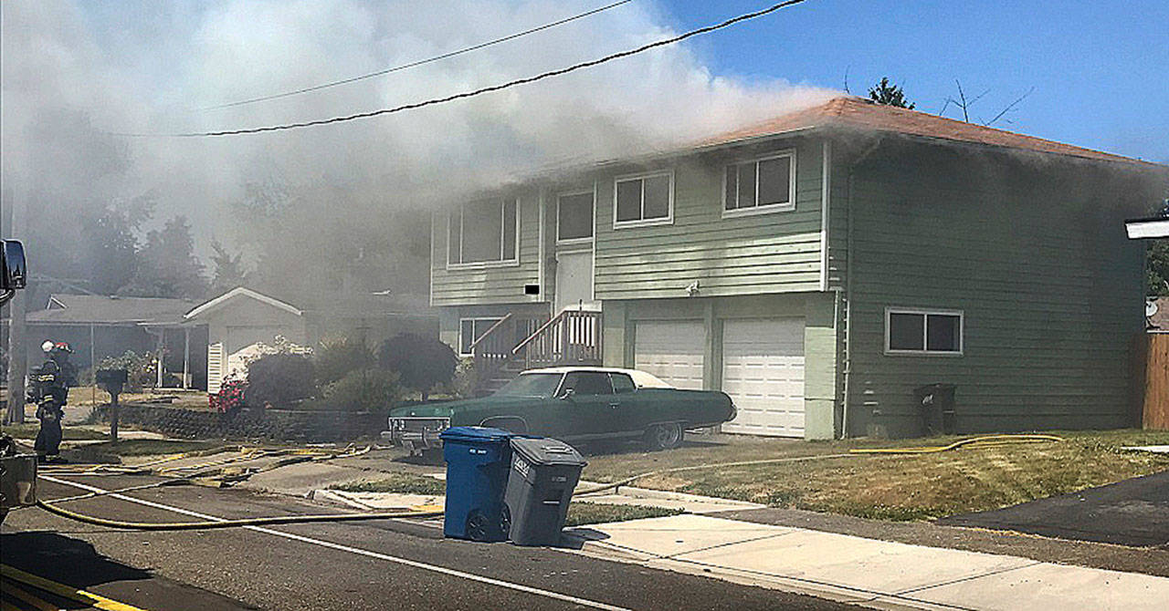 Fire breaks out at a Kent house Monday afternoon in the 10500 block of Southeast 236th Place. COURTESY PHOTO, Puget Sound Fire