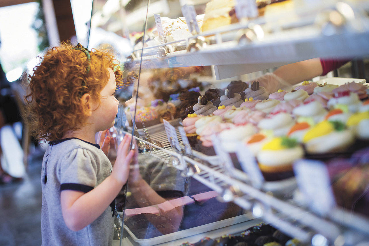 A child looks into the tasty possibilities on display at Sweet Themes Bakery in Kent. COURTESY PHOTO